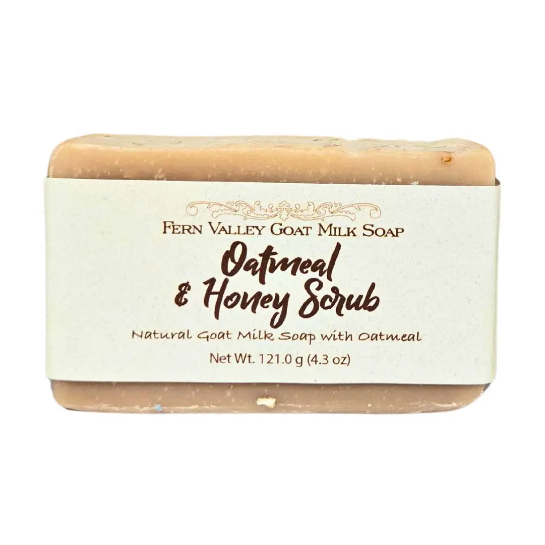 Oatmeal and honey goat milk soap bar with label on white background