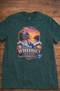 Green Whidbey Island custom T-shirt featuring a colorful lighthouse, sunset, ocean waves and island design with Where the Sound Meets the Sky
